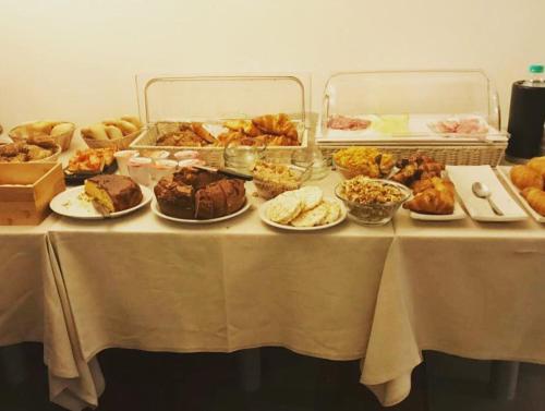 a table with many different types of food on it at Agorà Hotel in Calamandrana