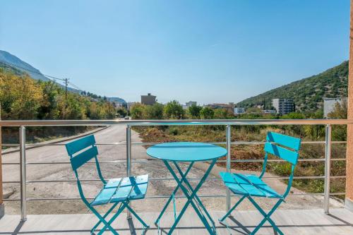 a table and two chairs on a balcony at Apartments DILARA in Čanj
