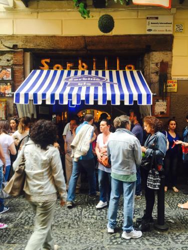 a crowd of people standing in front of a store at Casa Velata a Spaccanapoli in Naples