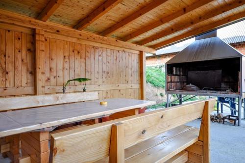 a wooden pavilion with a table and a grill at Room Anton in Rakovica