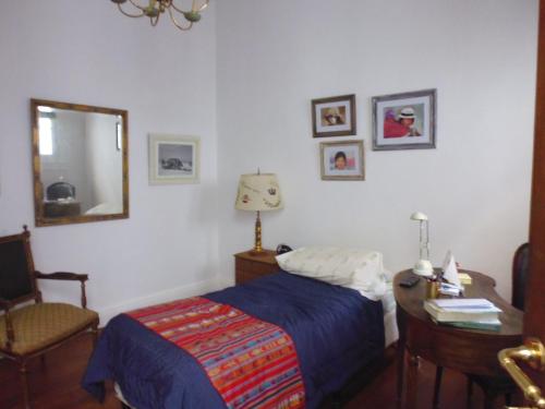 a bedroom with a bed and a desk and a mirror at Tu Lugar en Buenos Aires in Buenos Aires