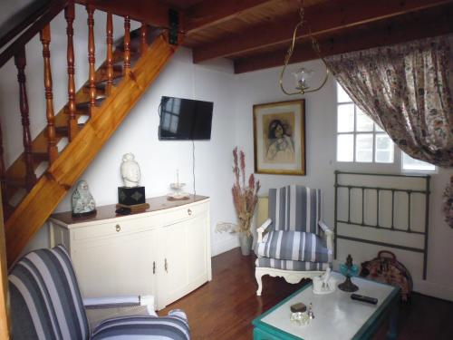 a living room with a staircase and a chair at Tu Lugar en Buenos Aires in Buenos Aires
