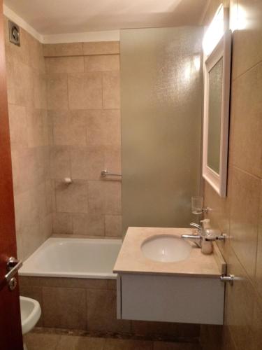 a bathroom with a bath tub and a sink and a bath tub at Avenida Cabildo 1535 in Buenos Aires