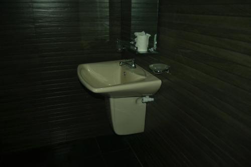 a bathroom with a sink and a toilet at The Citadel Guest House in Hikkaduwa
