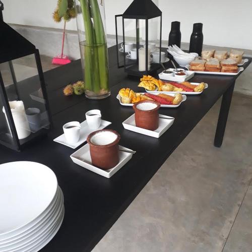 a black table with plates and food on it at South House-Weligama in Weligama