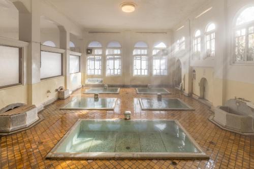 a large room with five sinks in a building with windows at Sekizenkan Kashotei Sanso in Nakanojo