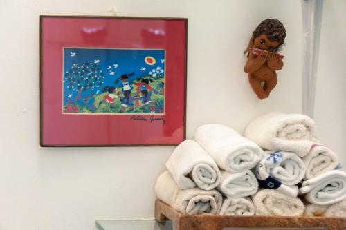 a pile of towels on a shelf next to a picture at Casa Itzae B&B Polanquito Dog Friendly in Mexico City