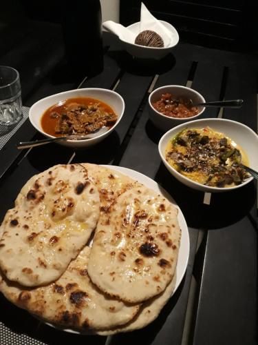 a table with plates of food and bowls of food at South House-Weligama in Weligama