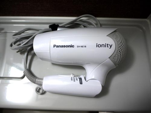 a white hair dryer with a cord plugged into it at Hotel Route Inn Kasai Hojonoshuku in Kasai