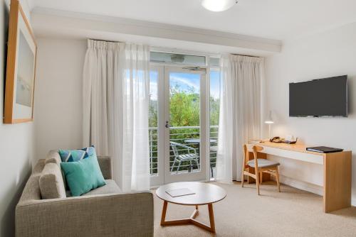 a living room with a couch and a desk at MainStay Suites Williamstown in Williamstown