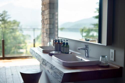 a bathroom counter with two sinks and a window at Fufu Kawaguchiko in Fujikawaguchiko