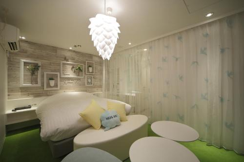 a living room filled with furniture and pillows at HOTEL SPARK (Adult Only) in Sendai