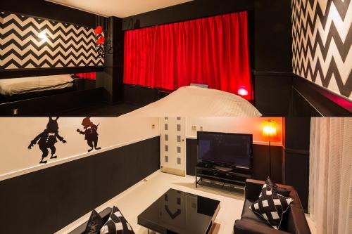 a living room with a bed and a tv at Hotel Aqua Color (Adult only) in Fukushima