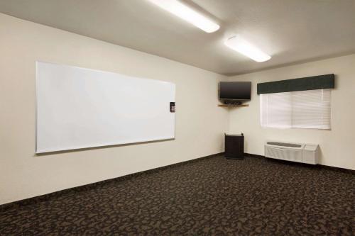 a room with a large white screen on the wall at Travelodge by Wyndham Pecos in Pecos