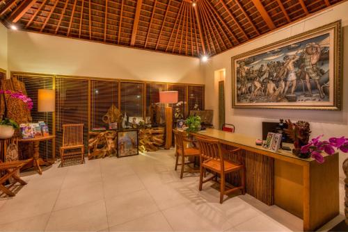 a living room with a large painting on the wall at Villa Bali Asri Batubelig in Seminyak