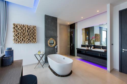a bathroom with a large tub and a sink at Villa Momo Private Pool near Kata Beach in Kata Beach