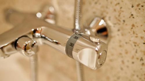 a close up of a bathroom sink faucet at Hotel Astoria in Hunedoara