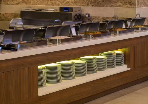 a buffet line with plates and food on display at Ramada Plaza by Wyndham Rize in Rize