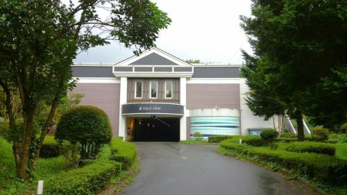 a large building with a garage in front of it at Hotel Aqua Vitae (Adult Only) in Nasu