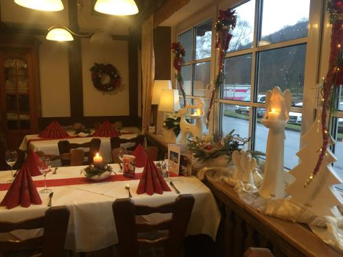 a dining room with two tables with candles on them at Landhotel Menke in Brilon