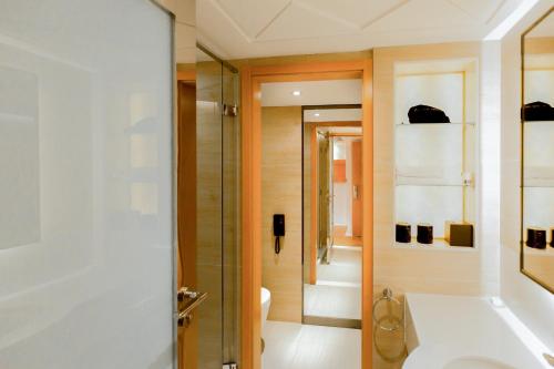 a bathroom with a shower and a sink and a toilet at Nanjing Central Hotel in Nanjing