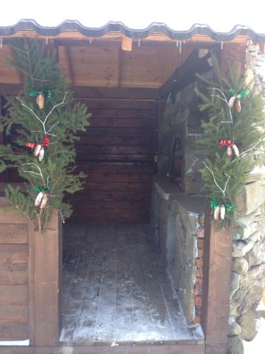 a wooden structure with christmas trees in it at Leoslav Apartments in Tatariv