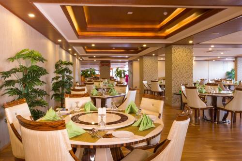 a dining room with tables and chairs in a restaurant at The Grand Kandyan in Kandy
