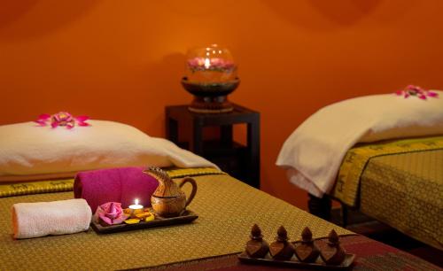 a room with two beds with a candle on a table at Golden Temple Hotel in Siem Reap