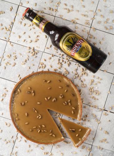 a bottle of beer sitting next to a chocolate cake at SALT of Palmar, an adult-only boutique Hotel in Belle Mare