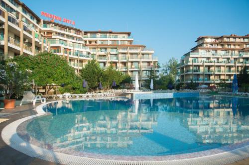 a large swimming pool in front of a building at Aparthotel Hotel Prestige City II in Primorsko