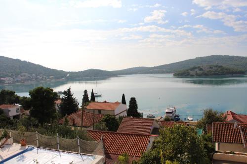 a view of a large body of water with houses at Apartments Maria in Tisno