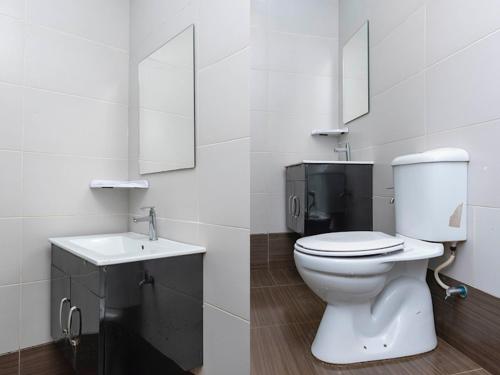 a white bathroom with a toilet and a sink at I Leaf Boutique Hotel in Johor Bahru