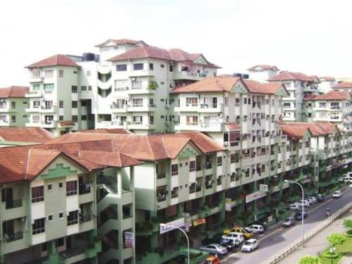 a large building with red roofs on a city street at Api Api Centre Apartment Homestay in Kota Kinabalu