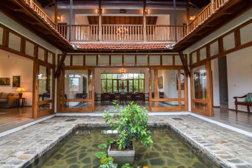 an indoor pool in the middle of a room with a house at Niketh Villa Kandy in Kandy