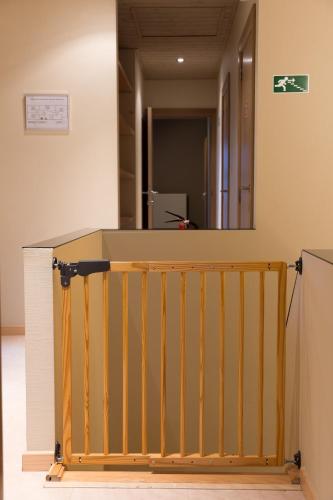 a room with a wooden railing and a mirror at VILLA WESTHOEK in Poelkapelle