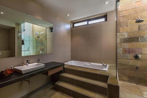 A bathroom at SaffronStays Aspen, Lonavala - luxury pool villa with games and TV room near Bhushi Dam