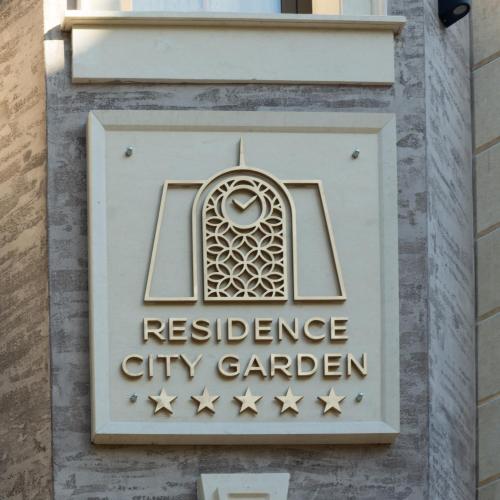a sign for a residence city garden on a building at Residence City Garden - Certificate of Excellence Top 10 BEST Five-Stars City Hotels for 2024 awarded by HTIF in Plovdiv