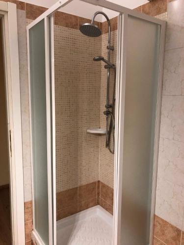 a shower with a glass door in a bathroom at Il Galileo Rooms in Pisa