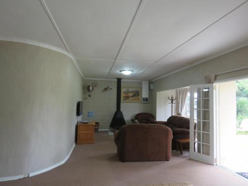 a living room with a couch and a table at Riverside Manor in Nottingham Road