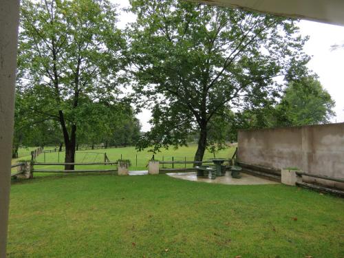 a park with a fence and a tree and grass at Riverside Manor in Nottingham Road