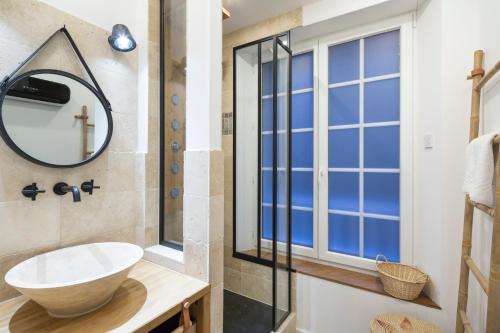 a bathroom with a sink and a mirror at La Cordee by Cocoonr in Saint Malo