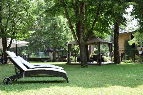 a bench sitting in the grass in a park at LH Albergo il Picchio in Pescasseroli