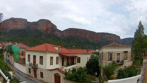 a group of houses in front of a mountain at Leonidio Rocks in Leonidion