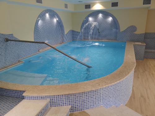 a swimming pool with a clock in the middle at Aparthotel Villa Marinù in Ischia