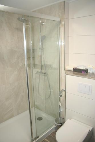 a bathroom with a glass shower with a toilet at Privat Unterkunft Schreiber in Winterbach