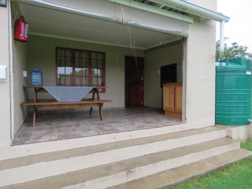 a patio with a bench on the side of a house at Riverside Manor in Nottingham Road