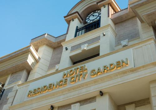 a building with a clock tower on top of it at Residence City Garden - Certificate of Excellence Top 10 BEST Five-Stars City Hotels for 2024 awarded by HTIF in Plovdiv