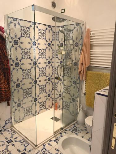 a glass shower in a bathroom with a toilet at Maison Elena in Mirano