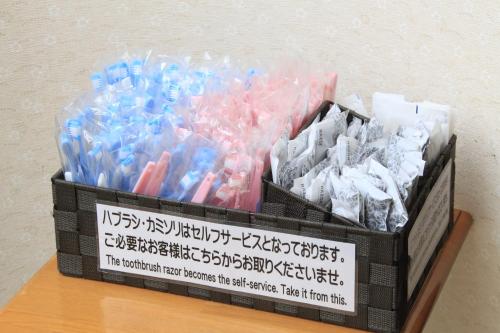 a bunch of toothbrushes in a box on a table at Fuji Green Hotel in Fuji