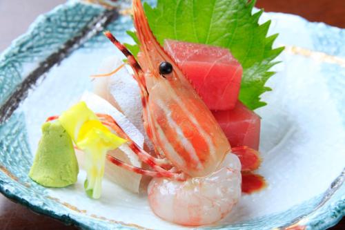 a plate of food with a shrimp and other foods at Fuji Green Hotel in Fuji